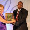 Diana Stewart, President of AMCHAM presents the 3rd prize in the AMCHAM Business & Civic Leadership Awards of Excellence – Corporate Social Responsibility category to Curtis Martin, Deputy Group President Banking & Investment Services & CEO, Capital & Credit Merchant Bank.  